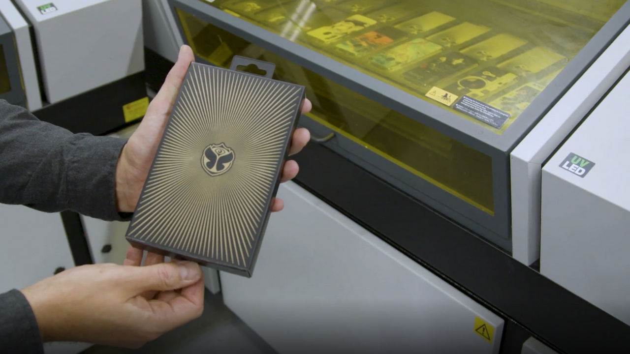 Bas van den Houten showcasing Tomorrowland’s branded phone case.
